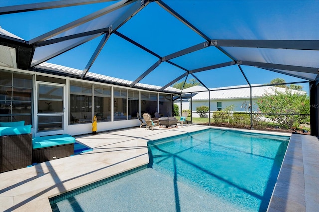 view of pool with a patio area and glass enclosure