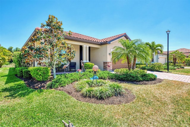 mediterranean / spanish-style home with a garage and a front lawn