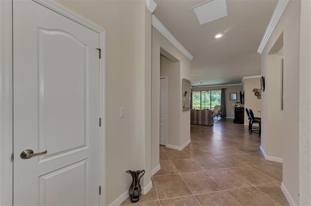 corridor featuring tile flooring and ornamental molding