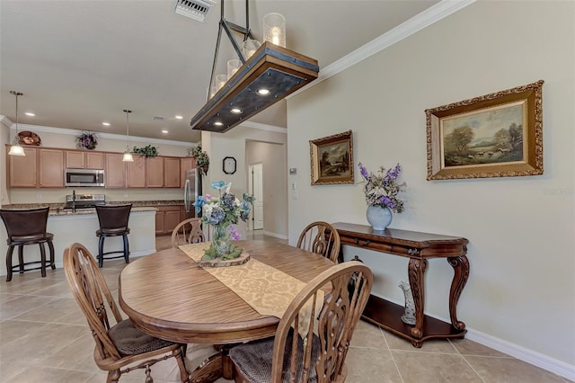 dining area featuring ornamental molding and light tile floors