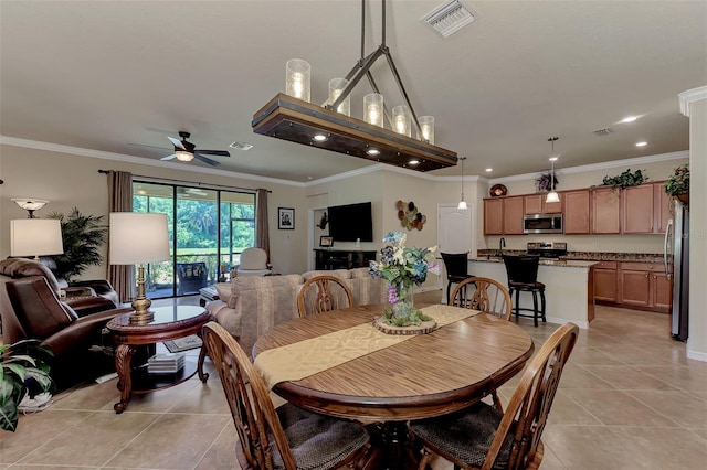 dining room featuring ceiling fan, light tile floors, and ornamental molding