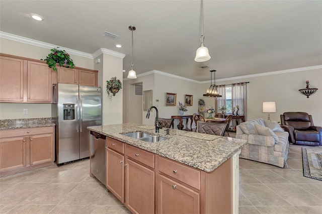 kitchen with stainless steel appliances, a kitchen island with sink, sink, pendant lighting, and light tile floors