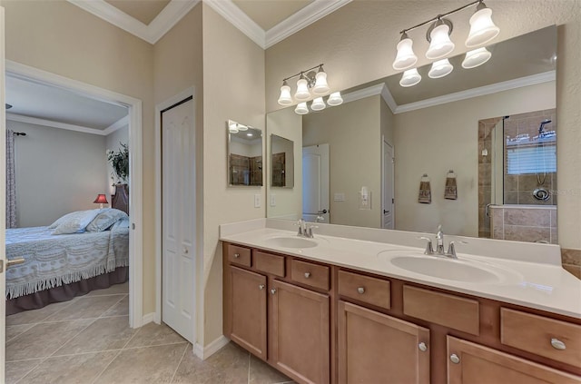 bathroom with vanity with extensive cabinet space, dual sinks, crown molding, a tile shower, and tile floors