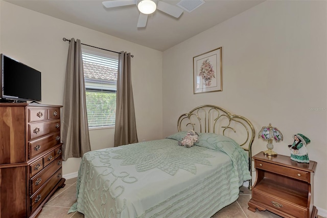 tiled bedroom featuring ceiling fan