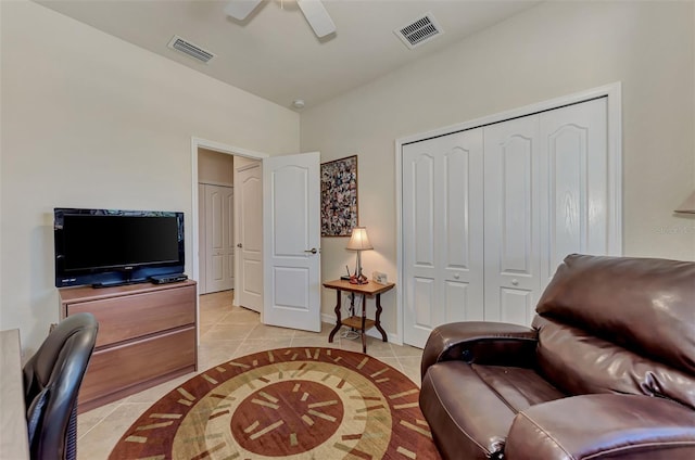 tiled living room featuring ceiling fan