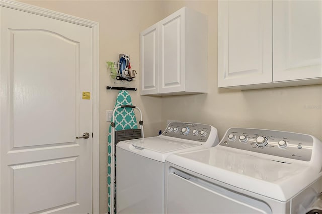 laundry room featuring cabinets and washing machine and clothes dryer