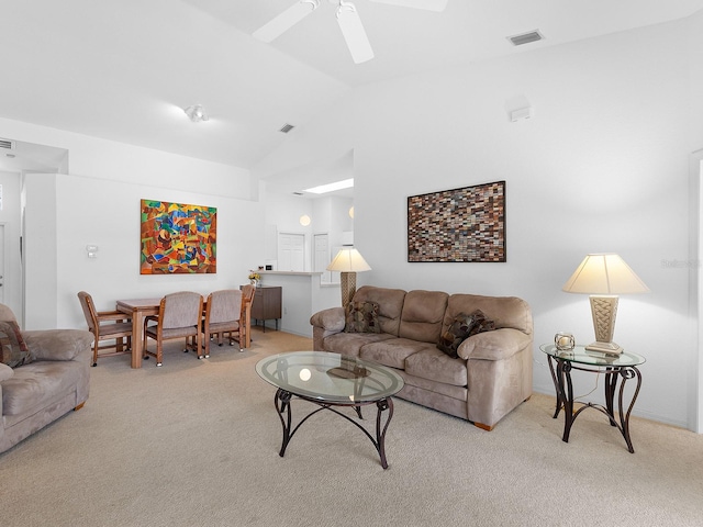 living room featuring ceiling fan, high vaulted ceiling, and light carpet