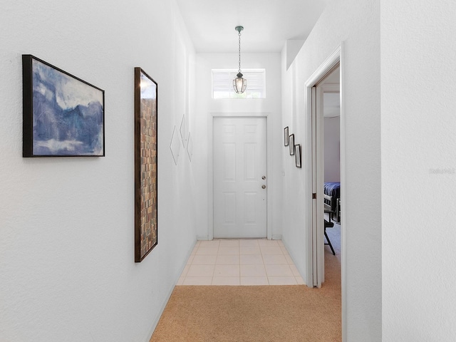 doorway featuring light colored carpet