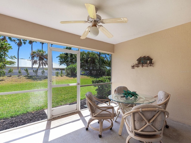 sunroom / solarium featuring ceiling fan