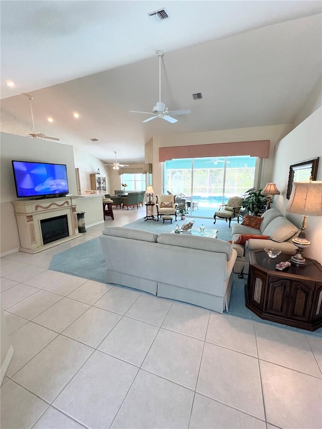 tiled living room featuring ceiling fan and high vaulted ceiling