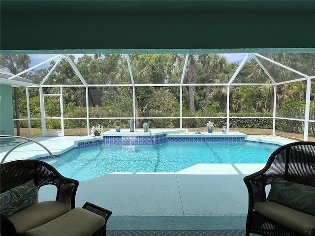 view of pool with a patio and a lanai