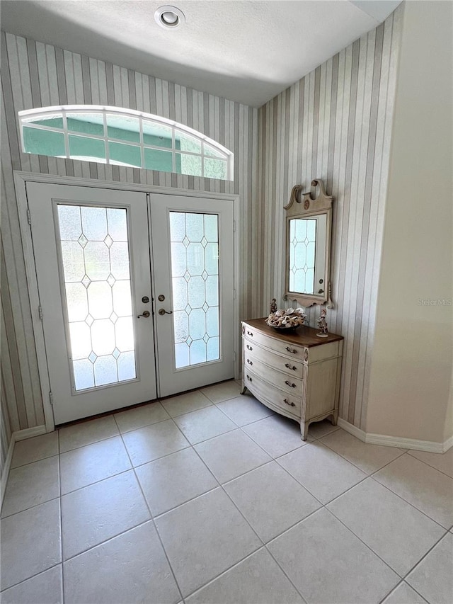 tiled foyer with a wealth of natural light and french doors