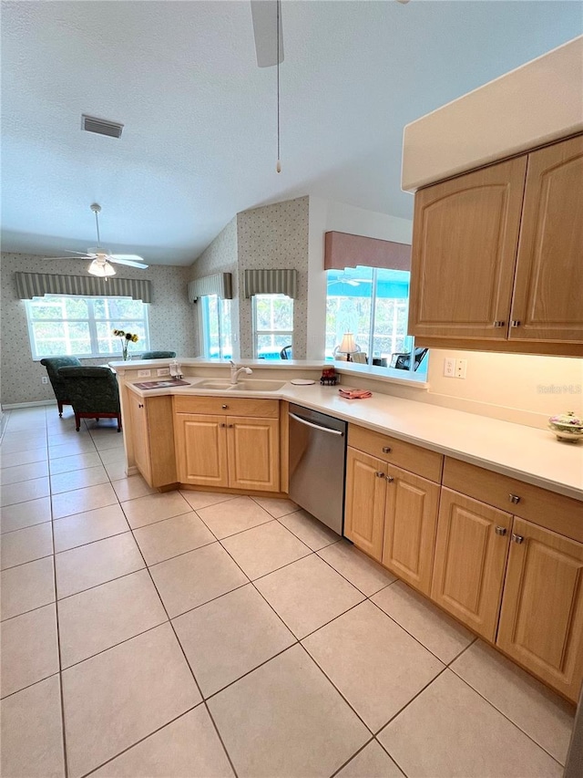 kitchen with dishwasher, sink, ceiling fan, light tile patterned floors, and a textured ceiling