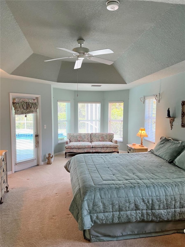 bedroom featuring access to outside, vaulted ceiling, ceiling fan, a textured ceiling, and light colored carpet