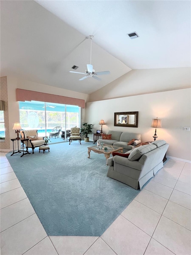 tiled living room featuring ceiling fan and lofted ceiling