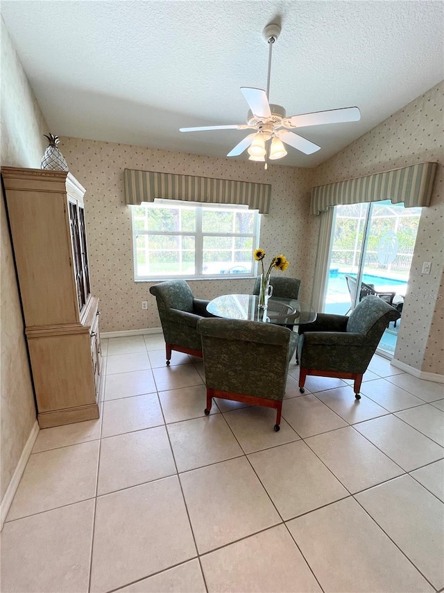 dining space featuring a wealth of natural light, light tile patterned flooring, a textured ceiling, and ceiling fan