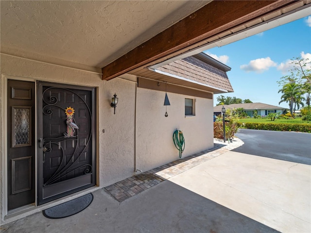 property entrance featuring a patio area