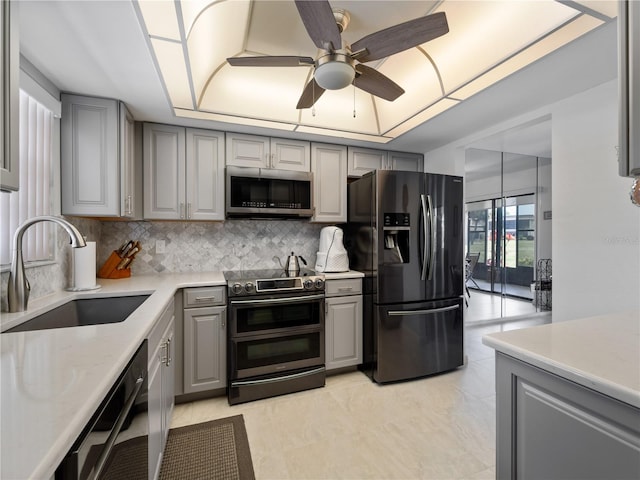 kitchen featuring black appliances, sink, and gray cabinets