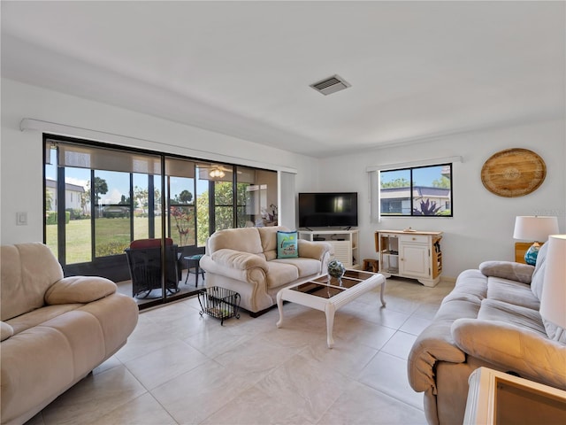 living room featuring light tile patterned flooring and a healthy amount of sunlight