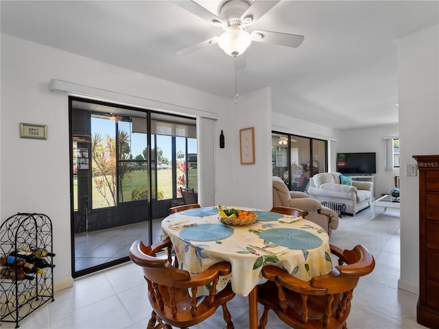 dining area featuring ceiling fan and light tile patterned flooring