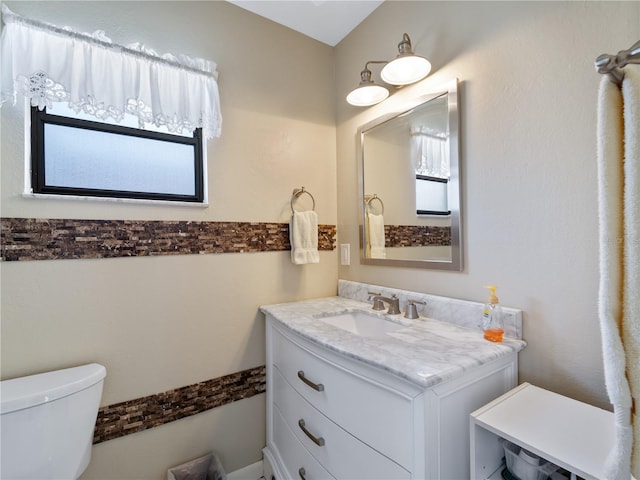 bathroom featuring toilet and vanity