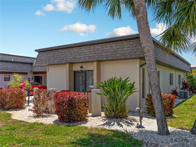 view of front of house featuring a front yard and cooling unit