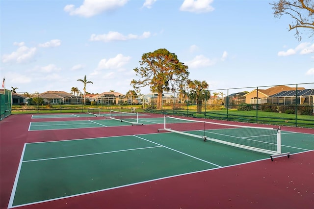 view of tennis court featuring basketball hoop