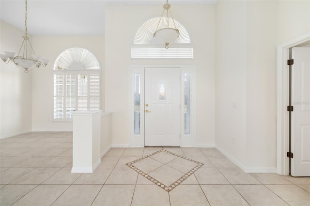 foyer with a notable chandelier and light tile patterned flooring