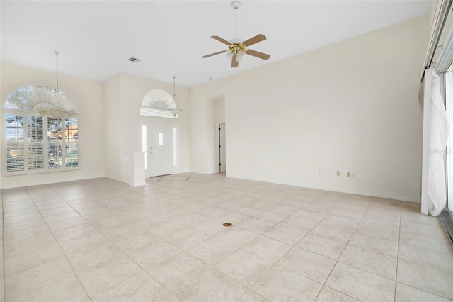 tiled spare room with ceiling fan