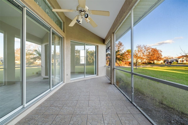 unfurnished sunroom with ceiling fan and lofted ceiling