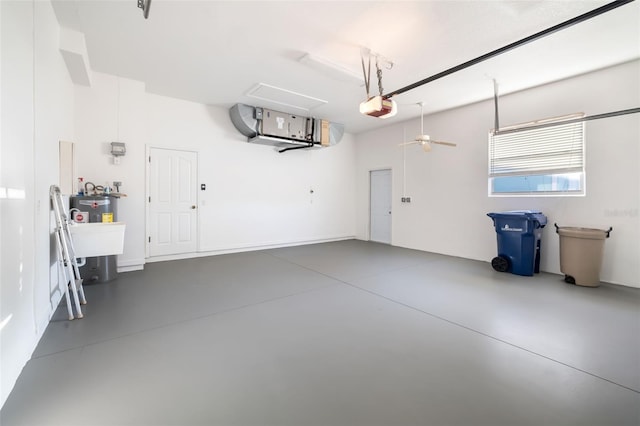 garage featuring ceiling fan, water heater, and a garage door opener