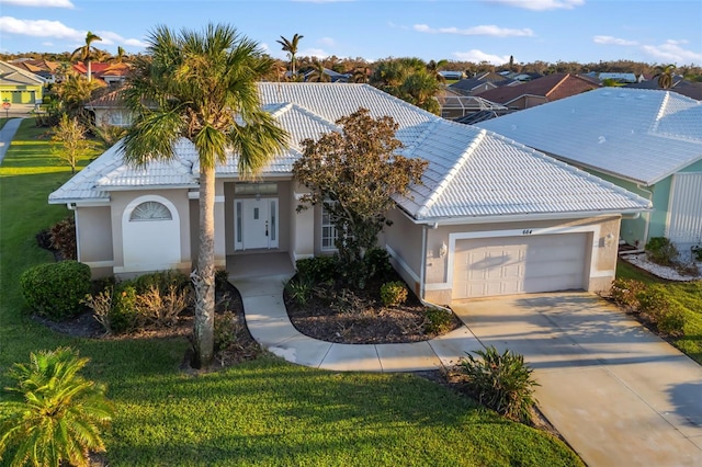 view of front of home with a front lawn and a garage