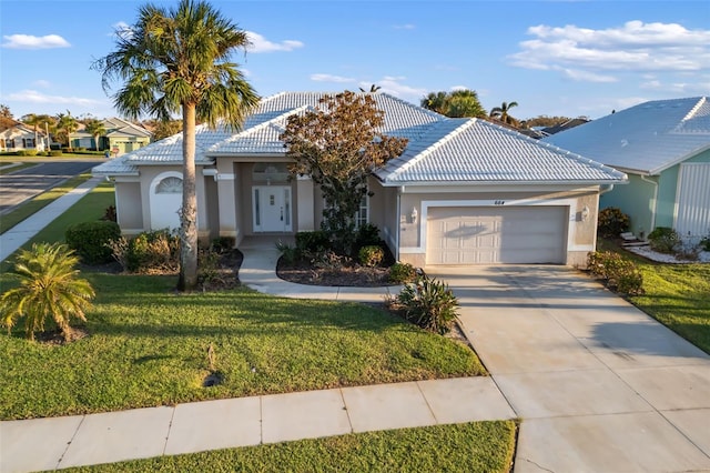 view of front of house with a garage and a front yard