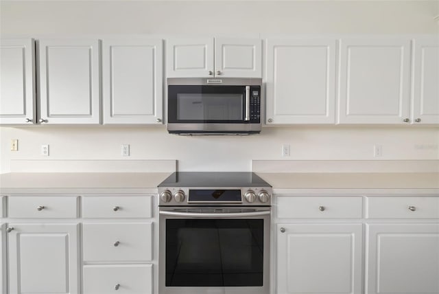 kitchen featuring white cabinets and appliances with stainless steel finishes