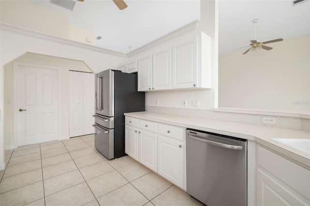 kitchen with light tile patterned floors, stainless steel appliances, white cabinetry, and ceiling fan