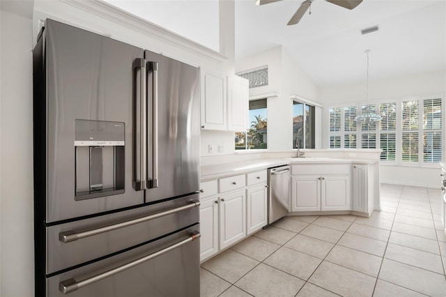 kitchen featuring lofted ceiling, white cabinets, ceiling fan, and appliances with stainless steel finishes