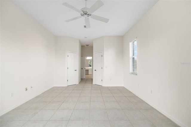 empty room featuring ceiling fan and light tile patterned flooring