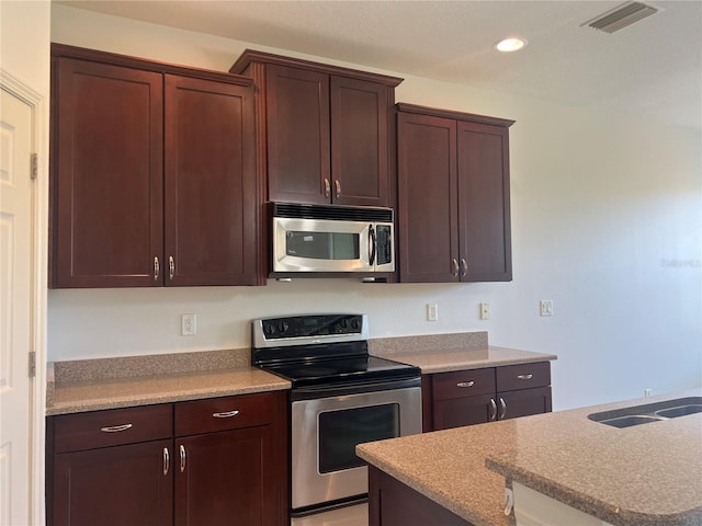 kitchen featuring appliances with stainless steel finishes and a kitchen island