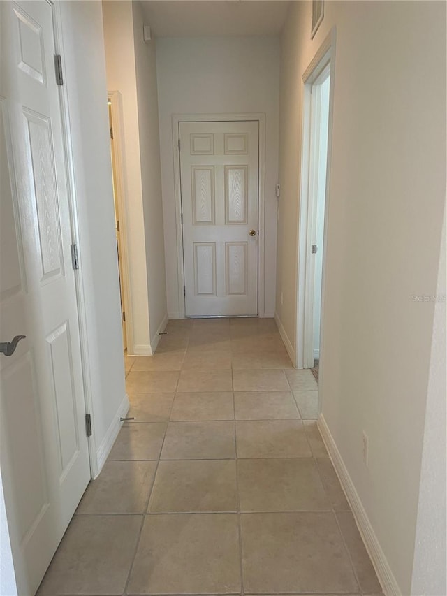 hallway with light tile floors