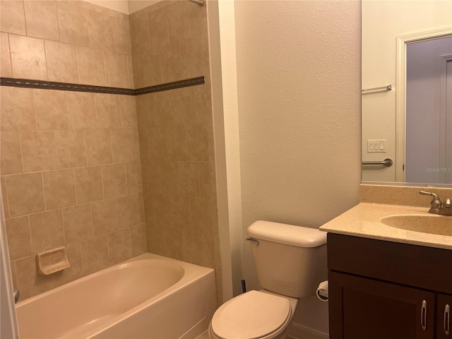 full bathroom featuring oversized vanity, tiled shower / bath combo, and toilet