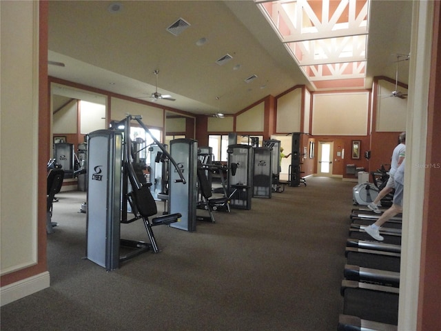 workout area featuring high vaulted ceiling, ceiling fan, and carpet flooring