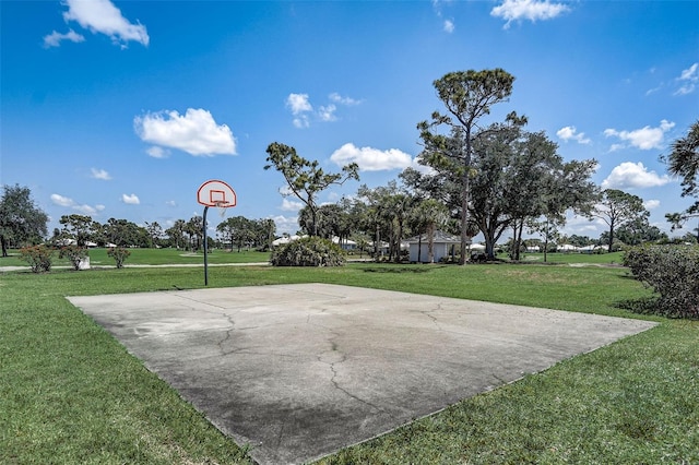 view of sport court with a lawn