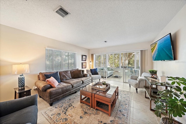 tiled living room featuring a textured ceiling