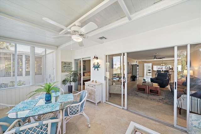 sunroom / solarium with beam ceiling and ceiling fan