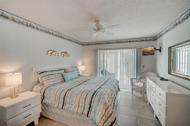 bedroom featuring multiple windows, light tile patterned floors, access to exterior, and a textured ceiling