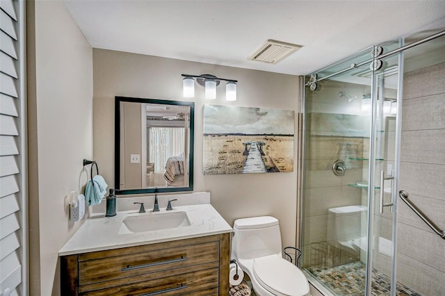 bathroom featuring vanity, toilet, and an enclosed shower