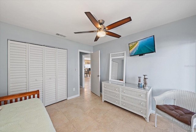 tiled bedroom featuring a closet and ceiling fan