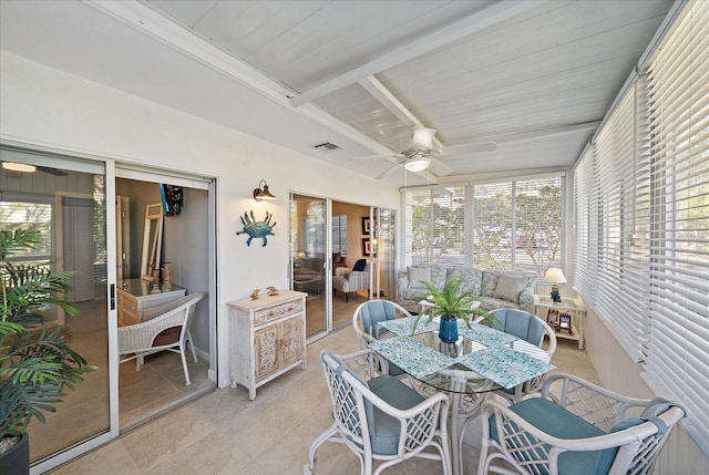 sunroom / solarium with beam ceiling and ceiling fan