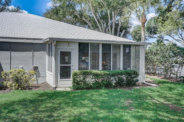 entrance to property with a lawn