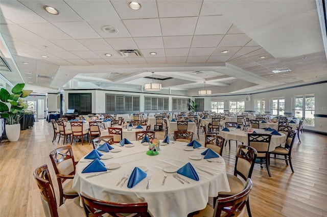 dining area featuring light hardwood / wood-style flooring and a drop ceiling